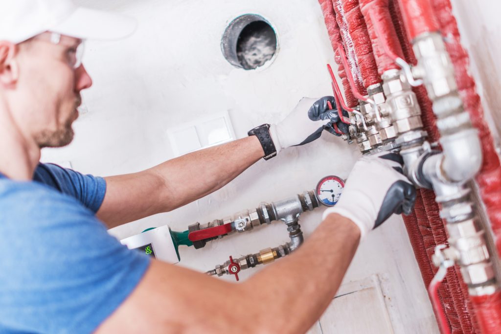 Plumber Kwinana from Perth Plumbing and Gasfitting looking at red pipes